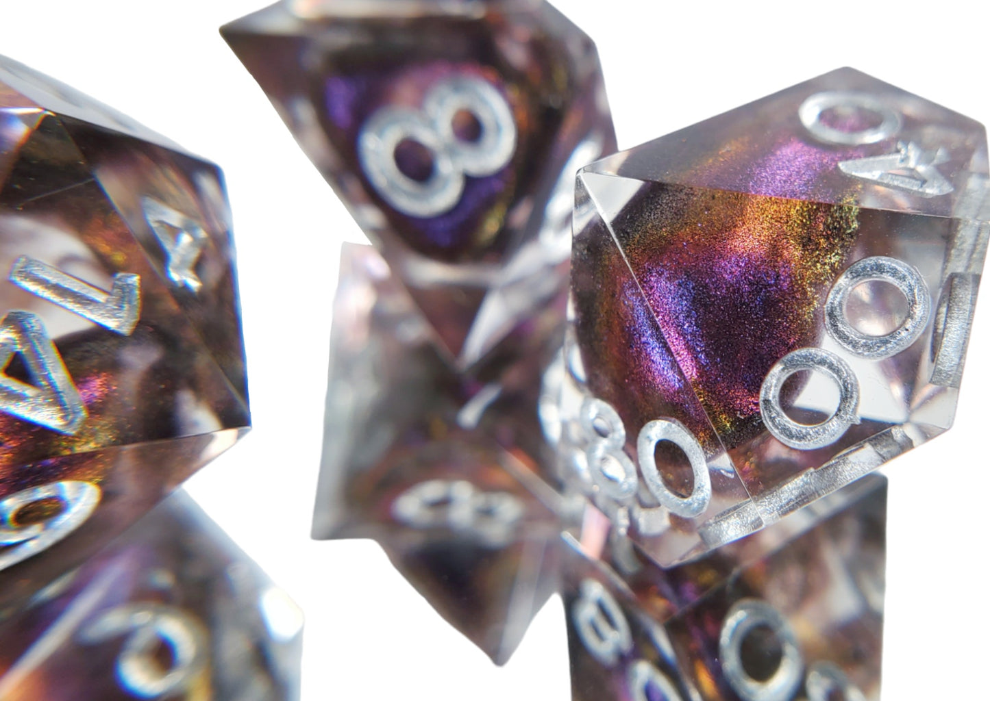 Closeup on the d100 of a dice set of clear resin with dark purple colorshifting shimmer bloops and silver numbering.